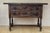Walnut console from the early 20th century with tablet top on a frieze with two drawer fronts decorated with carved with...