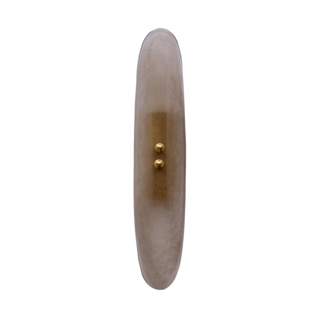 A sophisticated pair of contemporary Venetian wall sconces distinguished by their beautifully restrained silhouette and...