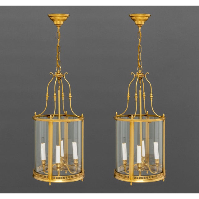 Pair of Regency Style Gilt Brass Hanging Lanterns, each with four candlestick form light fittings. 39" H x 12.25"...