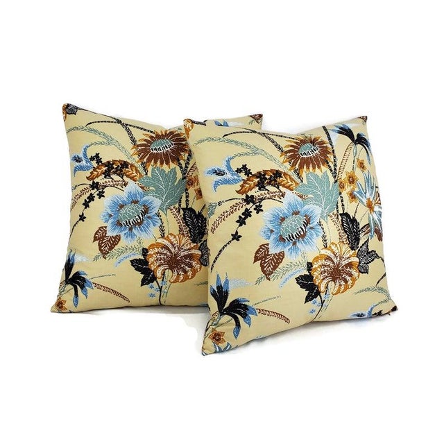 A decorative vintage floral pillow with blue and rust color print and cream background. This lovely pillow is cotton with...