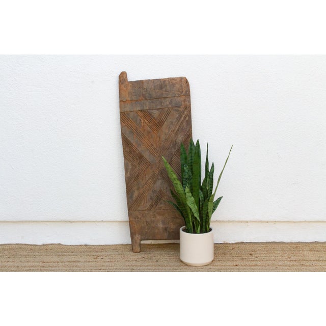 This 40.5-inch door (45.5 inches including its forked pivot tab) is a single-slab Igbo piece, hand-hewn from one solid...