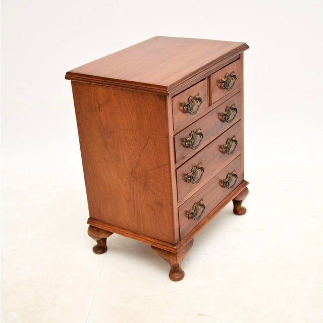 A charming antique walnut chest of drawers, made in England and dating from around the 1880-1900’s. It is of very small...