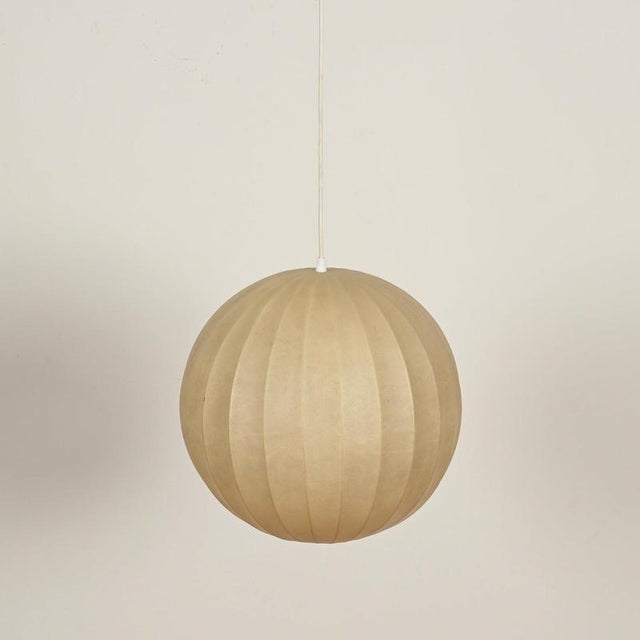 Stunning large round mid-century cocoon pendant lamp with a charming uniform beige patina. This gorgeous ceiling light was...