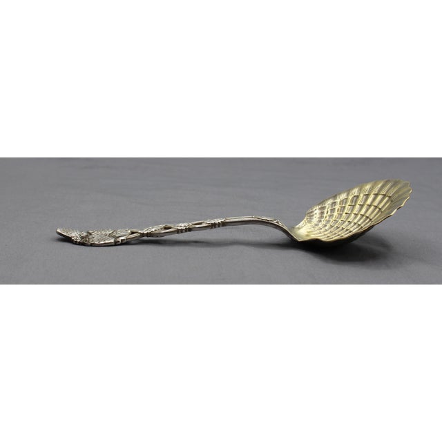 Tiffany & Co sterling & gold washed Strawberry Vine pattern serving spoon. The large scallop shell bowl accented by vine...