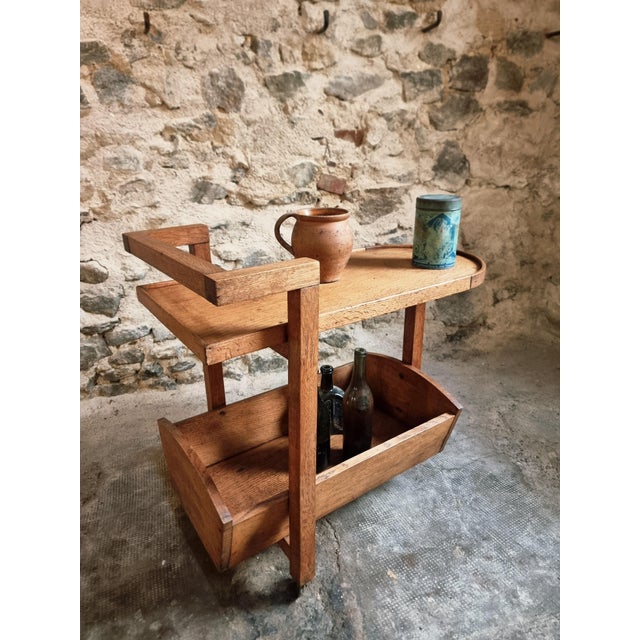 A French oak bar trolley from the 1950s in solid wood. This practical piece has a warm, natural oak tone and stands on...