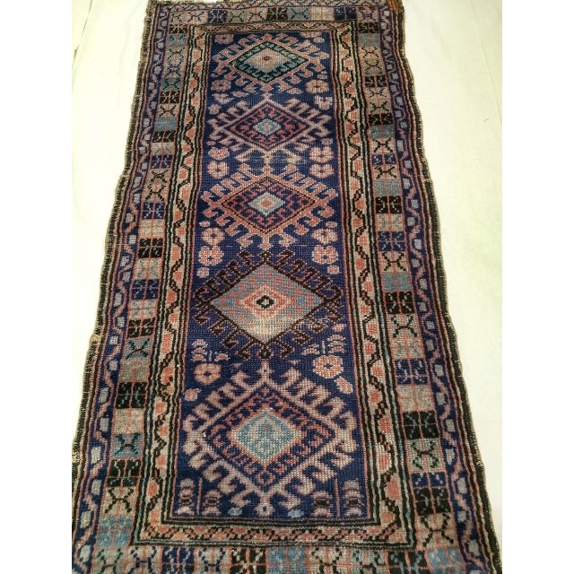 A vintage Kurdish area rug from the first quarter of the 20th century featuring a striking five-medallion design — a...