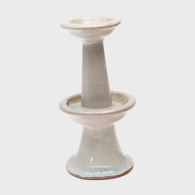 Elegant in its simplicity, this late 19th-century Chinese candle stand is decorated only by an allover pale glaze with...