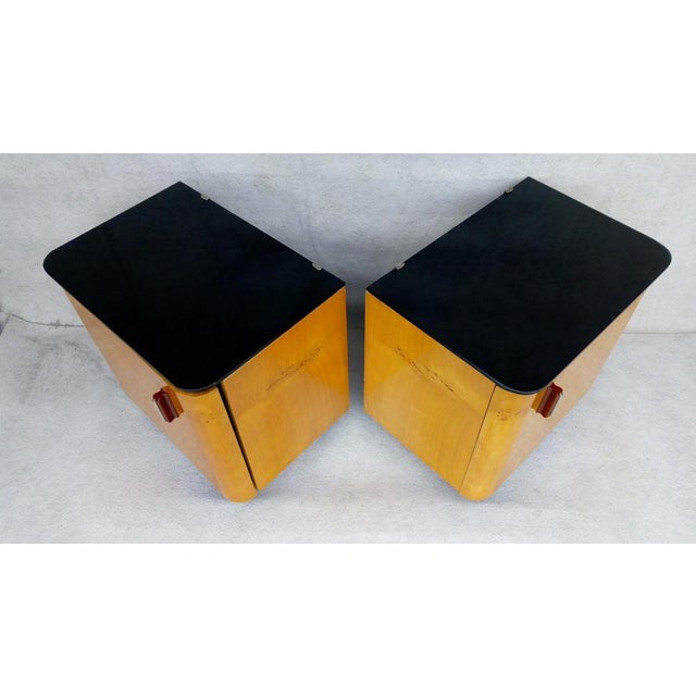 2 bedside tables in very well preserved original authentic condition. There is black glass on the top. The surface is...