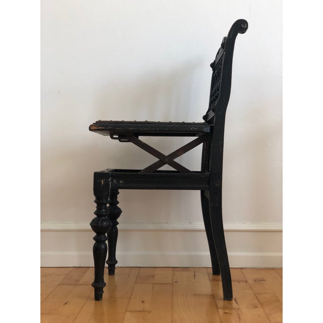 Victorian black-painted concert chair with an adjustable leather seat on a hinged mechanism, crafted around 1900. The...