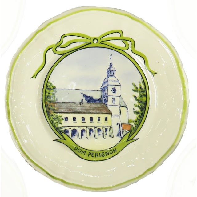A charming set of 5 faience plates featuring hand-painted images of famous wine domaines in France -- Dom Perignon,...