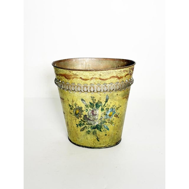 A charming antique decorative basket made of painted sheet metal, featuring a golden-yellow patina with an aged finish and...