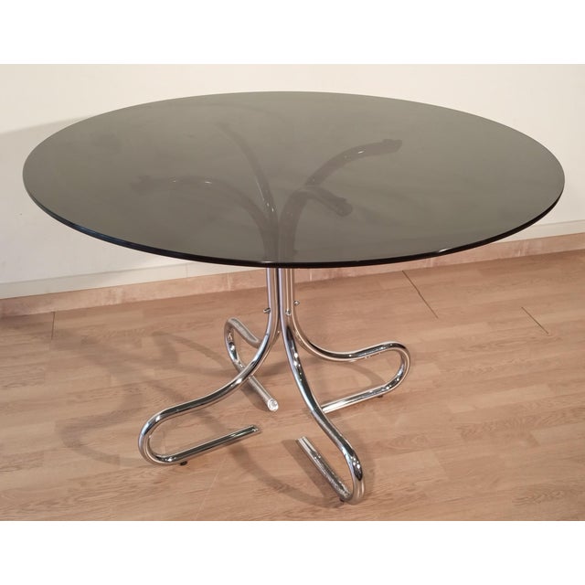 Discover the timeless elegance of this smoked glass chrome coffee table, a true masterpiece of vintage Italian design....