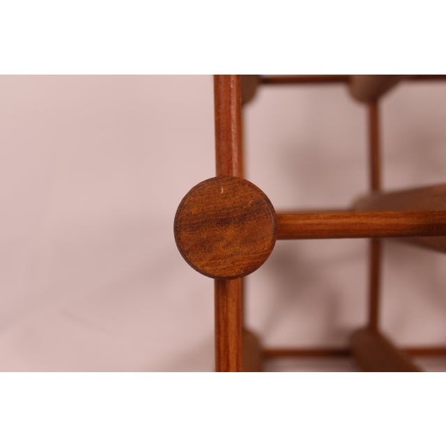 A Danish mid-century modern wine rack Made in Denmark Stamped emblem Produced by Nissen Circa 1960 Teakwood material