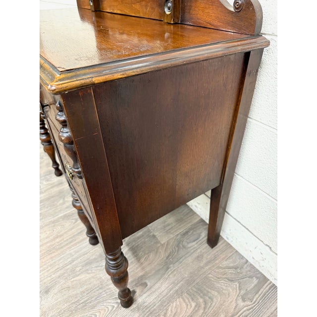 This is a gorgeous antique Art Nouveau walnut vanity featuring its original adjustable mirror, dovetailed drawers, brass...