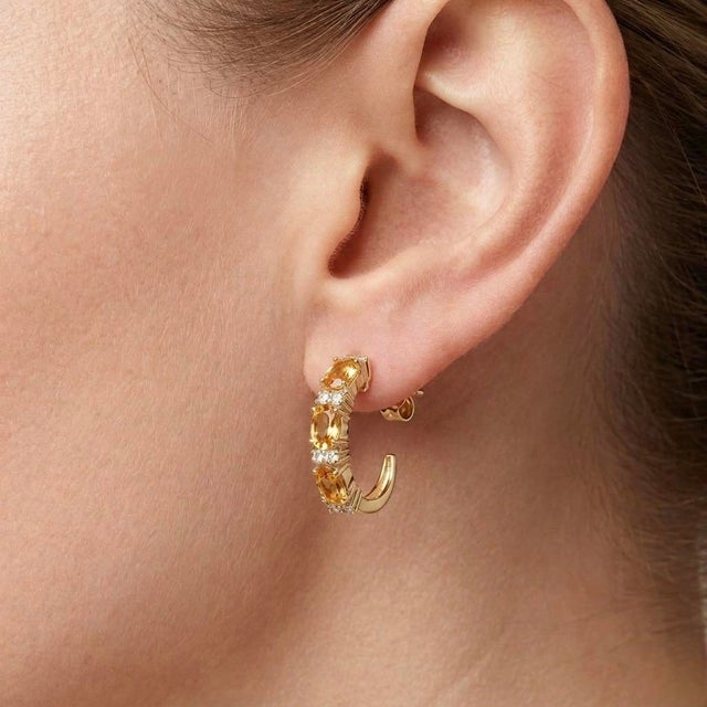 Bright, elegant, and effortlessly sophisticated, these Citrine Hoop Earrings feature a stunning row of vibrant oval-cut...
