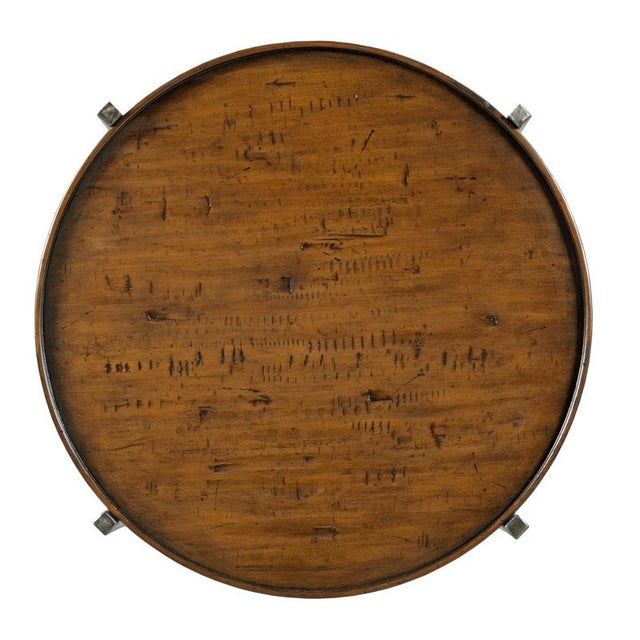 This table features graceful reverse tapering metal legs supported by a round top with gallery.