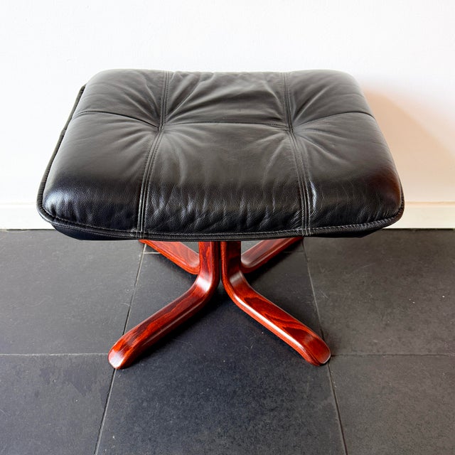 This rare ikea lindos footstool from 1997 is a scandinavian modern design featuring black leather upholstery and a...