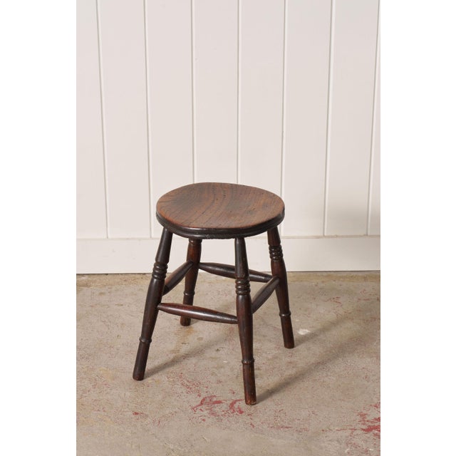 19th-century oak joint stool with a rectangular plank top, square legs, and box stretchers, constructed using traditional...