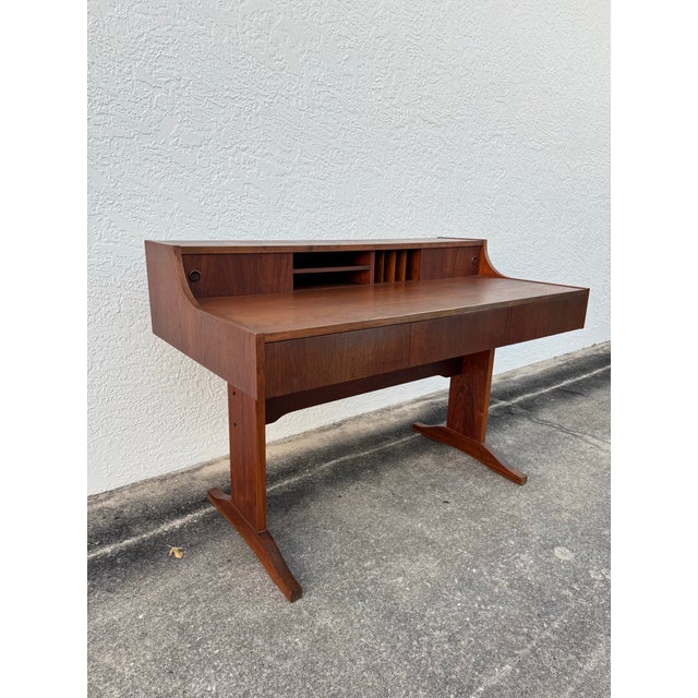 This piece embodies everything collectors love about MCM furniture—clean lines, minimalist form, and functional...