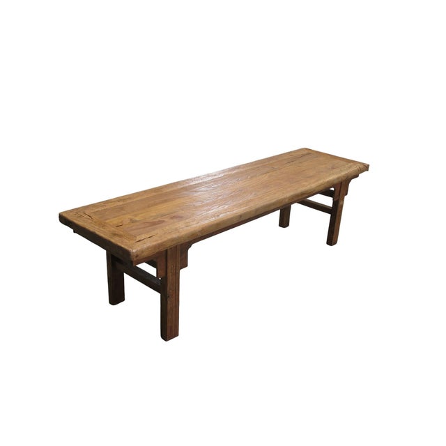This antique Chinese elm bench showcases a blend of traditional craftsmanship with its classic inset flush top and...