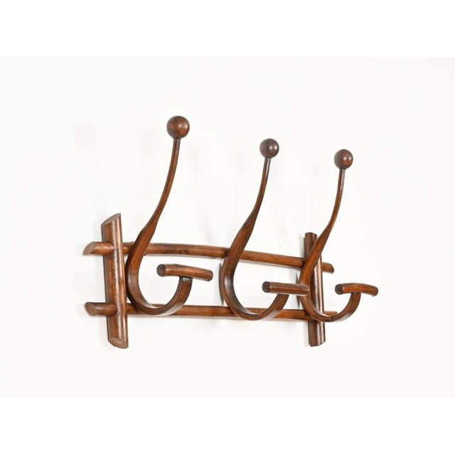 Stunning and sculptural Art Nouveau coat rack crafted in solid bent walnut. This refined piece was produced in the early...