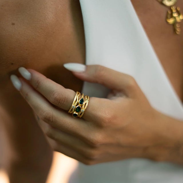 The Emerald & Diamond Regal Adjustable Gold Ring is a bold yet elegant design that radiates timeless charm. Featuring...