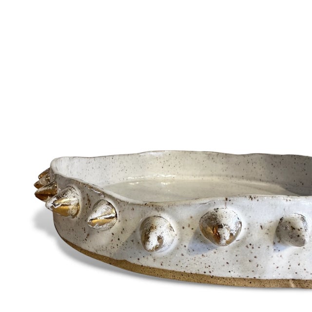Sculptural, textural, and undeniably bold. This handcrafted ceramic bowl features striking spike details along the outer...