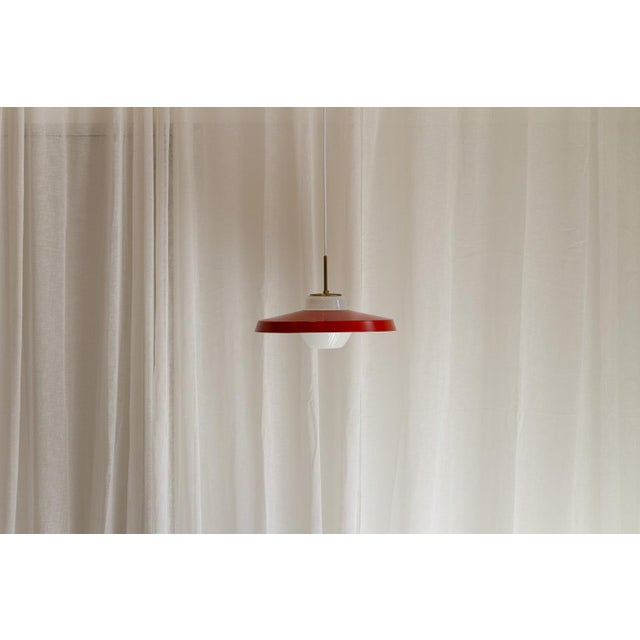 Danish Red and Opaline Pendant by Lyfa, 1950s. Scandinavian Mid-Century Modern ceiling lamp in white opal glass with brass...