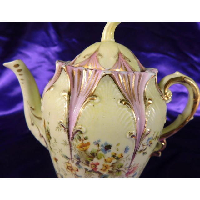 This is an unmarked green and purple floral creamer. It is kind of large for a creamer, but maybe too small for a teapot...