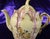 This is an unmarked green and purple floral creamer. It is kind of large for a creamer, but maybe too small for a teapot...