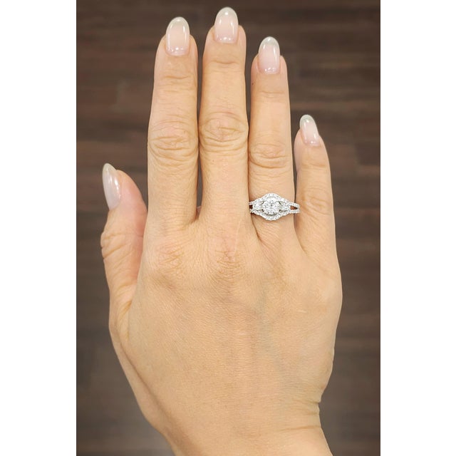 This stunning 1.06 ct diamond ring features 58 round-cut natural diamonds set in 18k white gold. The center stone weighs...