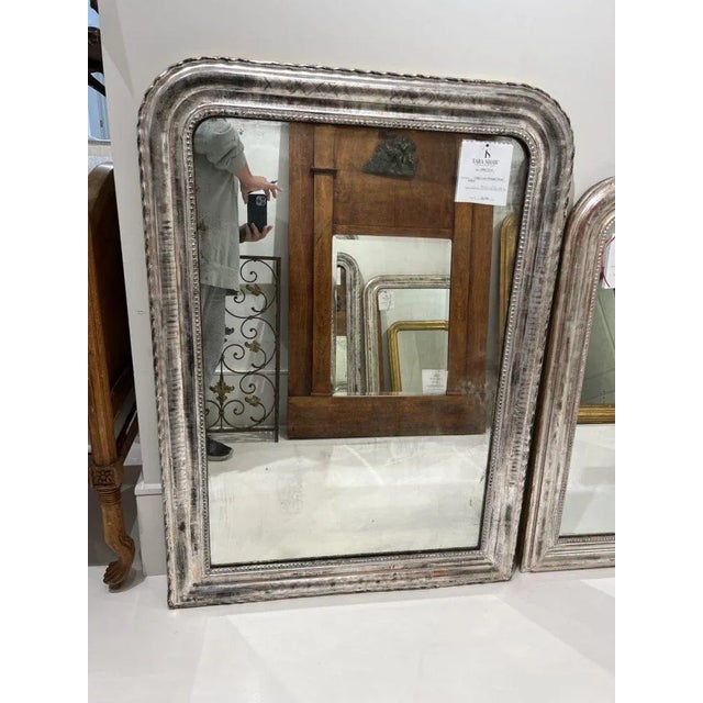 Large silver Louis Phillippe mirror with fine details.