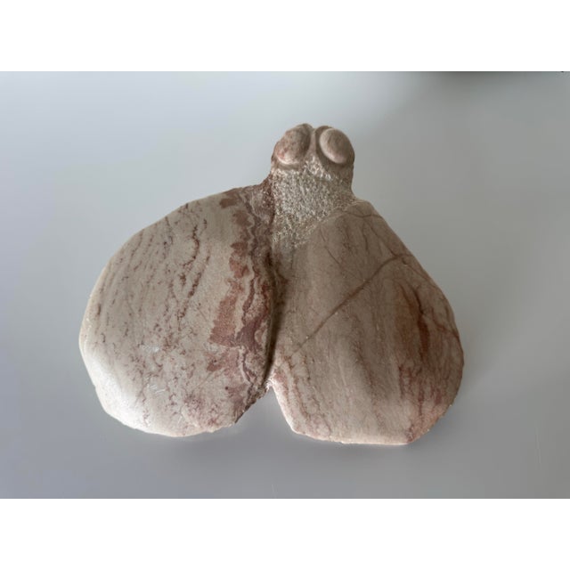 A striking 1980s vintage hand-carved marble sculpture depicting an abstract fly or insect form. Crafted from natural...