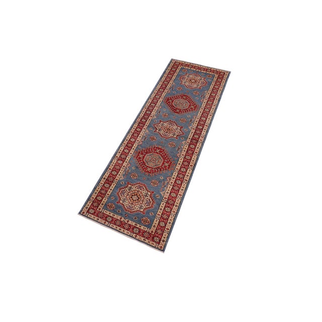 Enhance your home with this exquisite hand-knotted Super Kazak rug, crafted from fine hand-spun wool and dyed with all-...