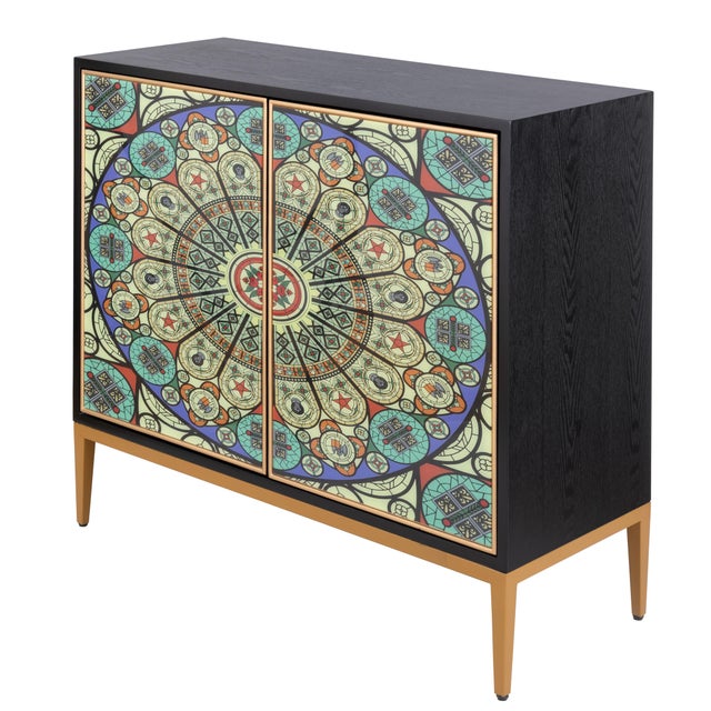 The Solani Cabinet is grounded in a rich, dark finish and lifted by a refined gold base that adds a modern, elevated...