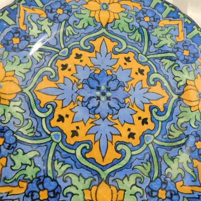 This is a Royal Doulton plate that is a thicker ceramic plate in a very colorful design. I have not been able to identify...