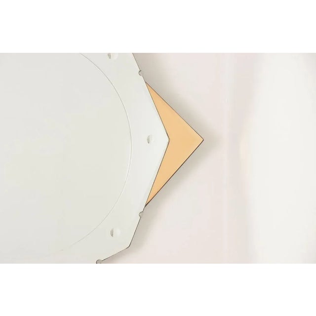 H: 69cm w: 69cm d: 2cm a british art deco star mirror with clear and peach mirror glass, slight fogging to the edges.