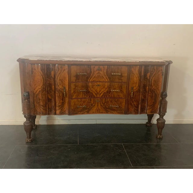 Wavy moved sideboards, with 2 doors on the sides and 3 drawers in the center. The feet finely carved in elongated pine...
