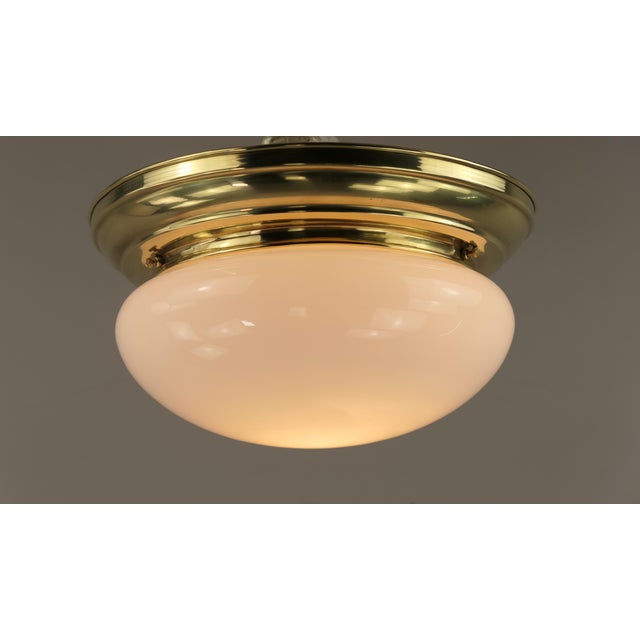 Ceiling light is fixed directly to the ceiling with 2 screws. polished surface. the lamp has been rewired and re-...