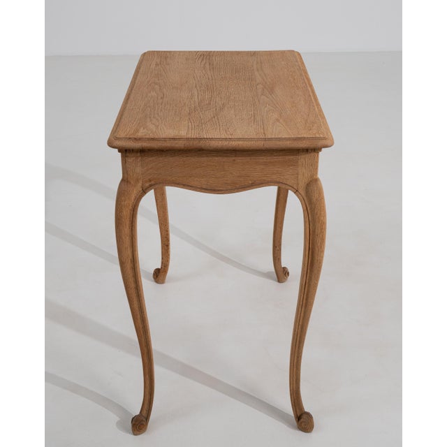 A 20th century French side table crafted in oak and designed in the Louis XV style, defined by its curved legs and shaped...
