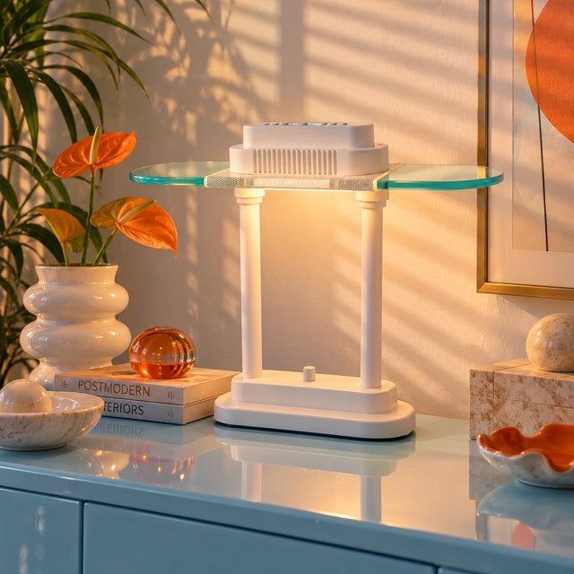 A vintage, 1980's-90's white metal and clear glass desk lamp, with a sculptural, postmodern form and rotary dimmer switch.