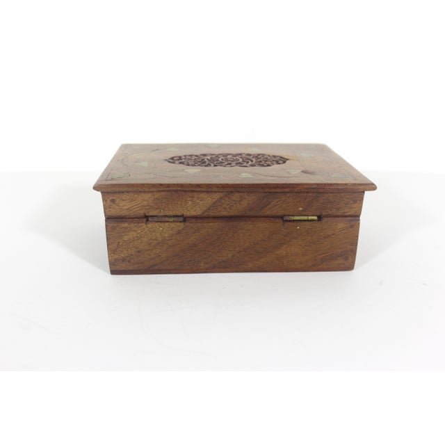 Lovely carved wood trinket box with brass inlay. The hinged lid opens easily. Good size perfect for jewellery, or to stash...