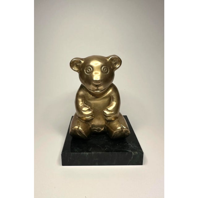 This bright eyed solid brass bear sits atop a square black and green marbler base. The piece would look great on a...