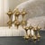 Crafted With An Antique Brass Finish, These Captivating Sculptures Feature Intricate, Multi-pointed Forms That Create A...