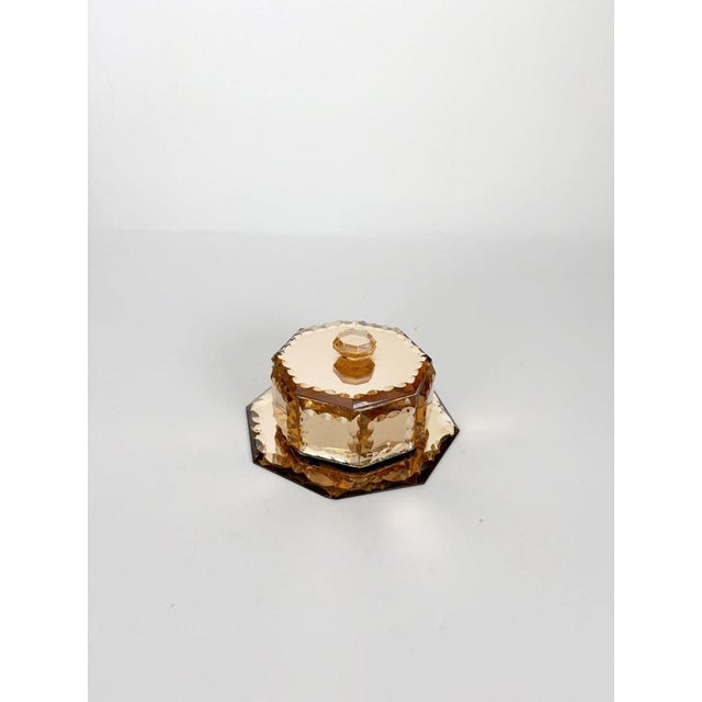 Elegant Art Deco glass trinket box crafted in France during the 1940s. Made from pink-tinted pressed glass, it features an...