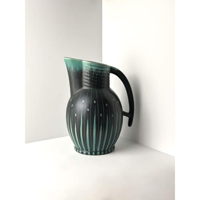 This Art Deco style ceramic pitcher, designed by Colin Melbourne for Beswick, England, is a bold example of mid-century...