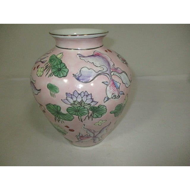 A vintage rose Chinese porcelain vase, hand-painted and decorated with incised designs of goldfish and water lilies....