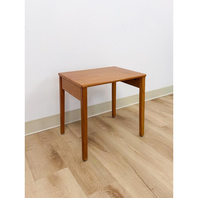 This lovely vintage MCM teak end table made in Denmark is a clean and well-crafted Danish modern accent find. The warm...