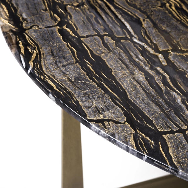 This coffee table features a 2 cm thick Black Forest and Spider marble top with gold leaf details resting on a brushed...