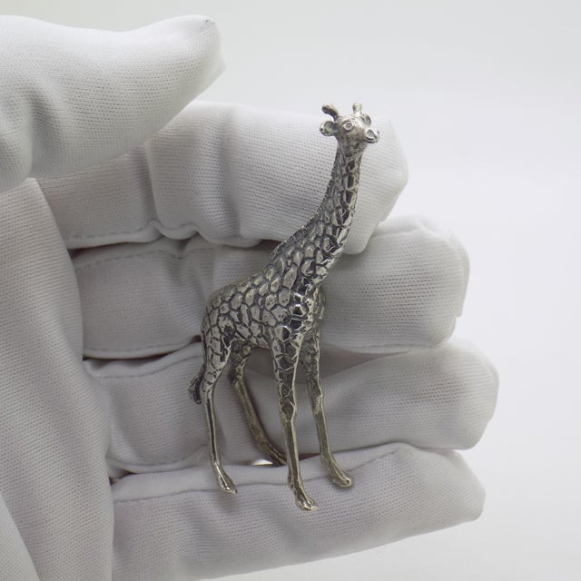 This vintage silver decorative object depicts a detailed giraffe figurine miniature, crafted as a cabinet curiosity, desk...